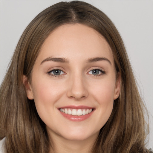 Joyful white young-adult female with long  brown hair and grey eyes