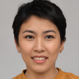 Joyful asian young-adult female with short  brown hair and brown eyes