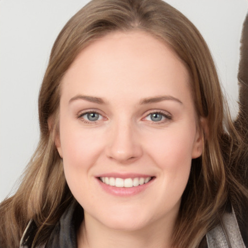 Joyful white young-adult female with long  brown hair and grey eyes