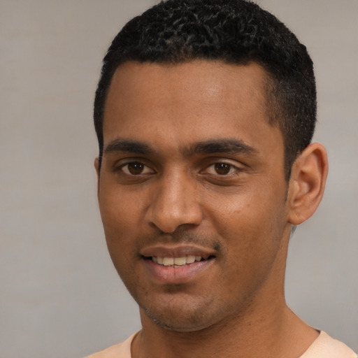 Joyful black young-adult male with short  black hair and brown eyes