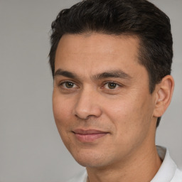 Joyful white young-adult male with short  black hair and brown eyes