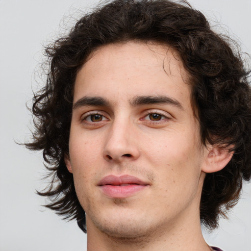 Joyful white young-adult male with medium  brown hair and brown eyes