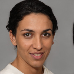 Joyful latino young-adult female with short  brown hair and brown eyes