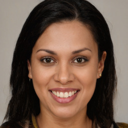 Joyful latino young-adult female with long  brown hair and brown eyes