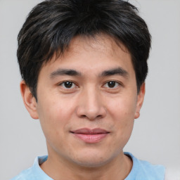 Joyful asian young-adult male with short  brown hair and brown eyes