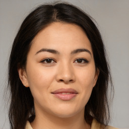 Joyful asian young-adult female with long  brown hair and brown eyes