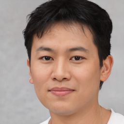 Joyful asian young-adult male with short  brown hair and brown eyes