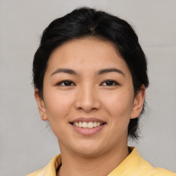 Joyful asian young-adult female with medium  brown hair and brown eyes