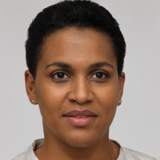 Joyful black young-adult female with short  black hair and brown eyes