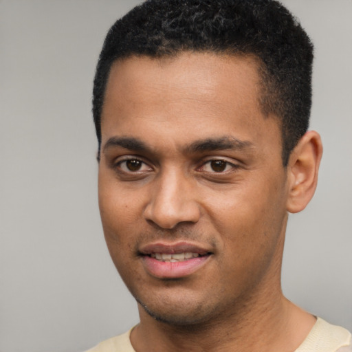 Joyful black young-adult male with short  black hair and brown eyes
