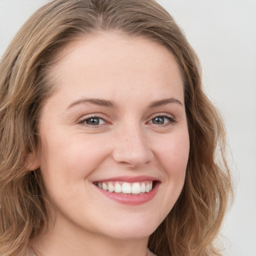 Joyful white young-adult female with long  brown hair and grey eyes