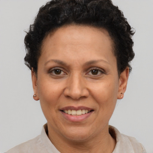 Joyful latino adult female with short  brown hair and brown eyes