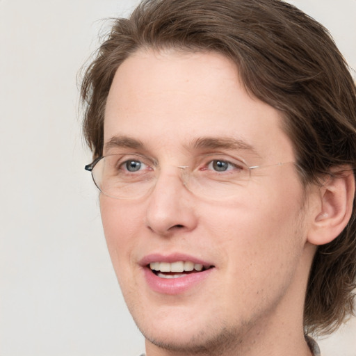 Joyful white adult male with medium  brown hair and brown eyes