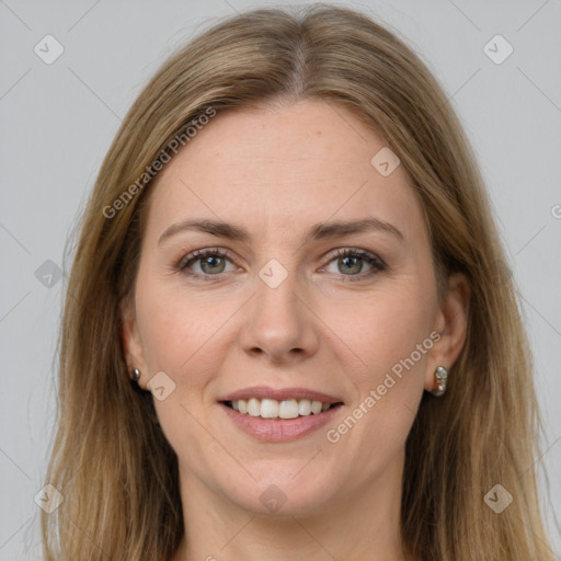 Joyful white adult female with long  brown hair and grey eyes