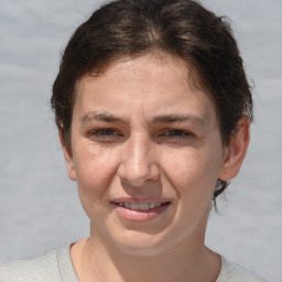 Joyful white adult female with short  brown hair and brown eyes