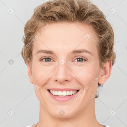 Joyful white young-adult female with short  brown hair and grey eyes