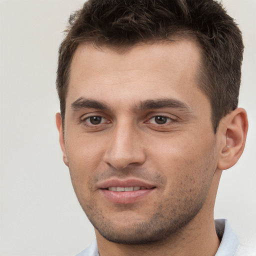 Joyful white young-adult male with short  brown hair and brown eyes