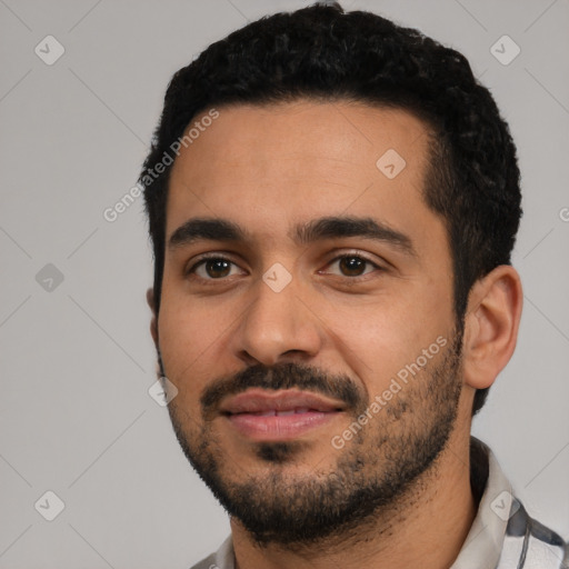 Joyful latino young-adult male with short  black hair and brown eyes