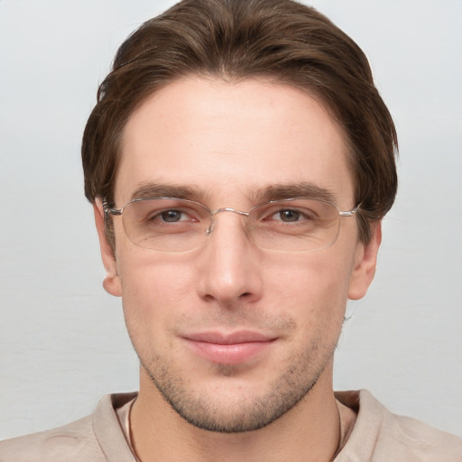 Joyful white young-adult male with short  brown hair and grey eyes