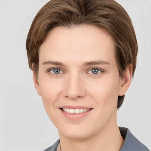 Joyful white young-adult female with short  brown hair and grey eyes