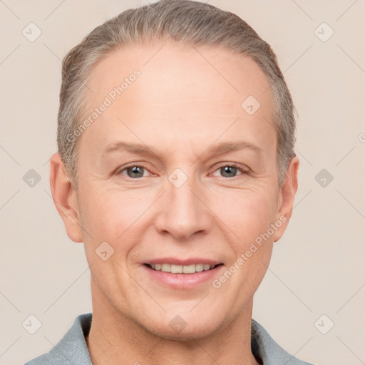 Joyful white adult female with short  brown hair and grey eyes