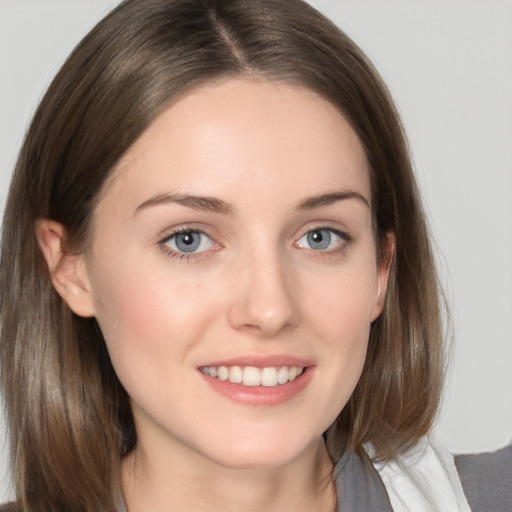 Joyful white young-adult female with medium  brown hair and grey eyes