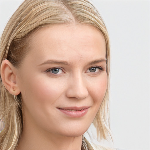 Joyful white young-adult female with long  brown hair and blue eyes