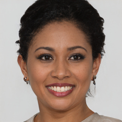 Joyful black young-adult female with short  brown hair and brown eyes