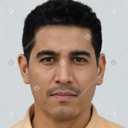 Joyful latino young-adult male with short  black hair and brown eyes