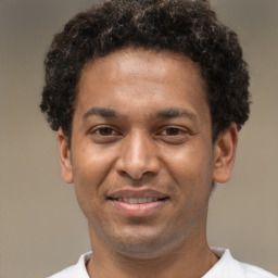 Joyful latino young-adult male with short  brown hair and brown eyes