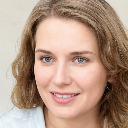 Joyful white young-adult female with medium  brown hair and green eyes