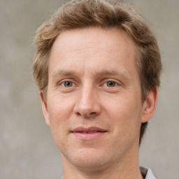 Joyful white adult male with short  brown hair and grey eyes