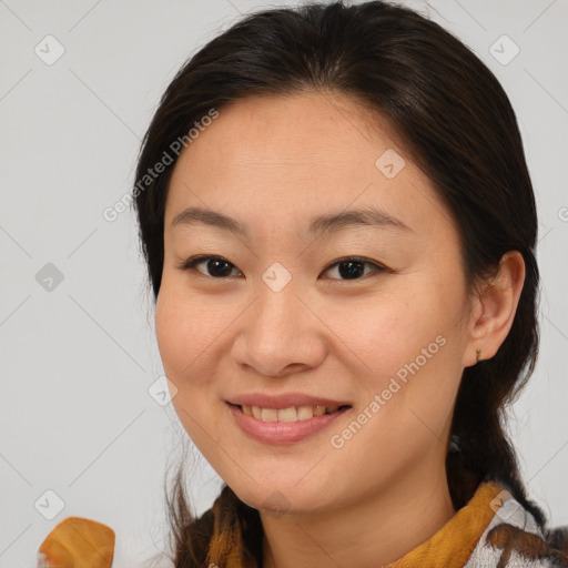 Joyful asian young-adult female with medium  brown hair and brown eyes