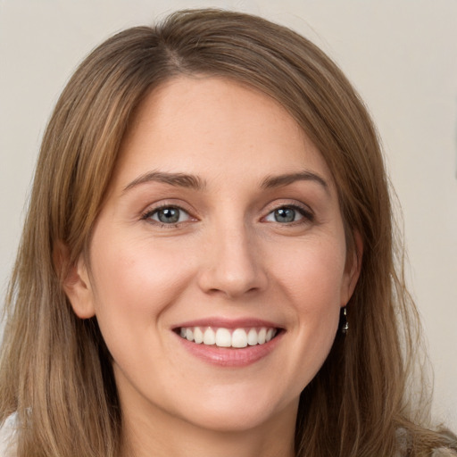 Joyful white young-adult female with long  brown hair and green eyes