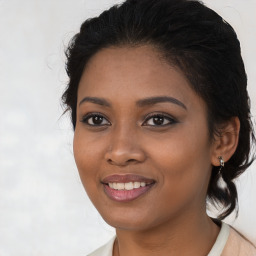 Joyful black young-adult female with medium  brown hair and brown eyes