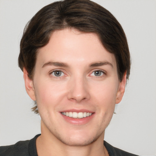 Joyful white young-adult female with short  brown hair and grey eyes