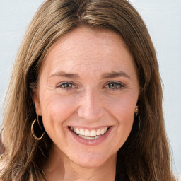 Joyful white young-adult female with long  brown hair and grey eyes