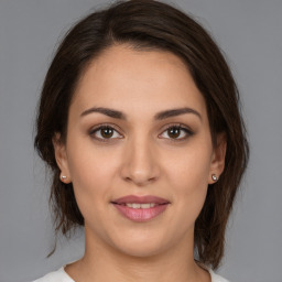 Joyful white young-adult female with medium  brown hair and brown eyes