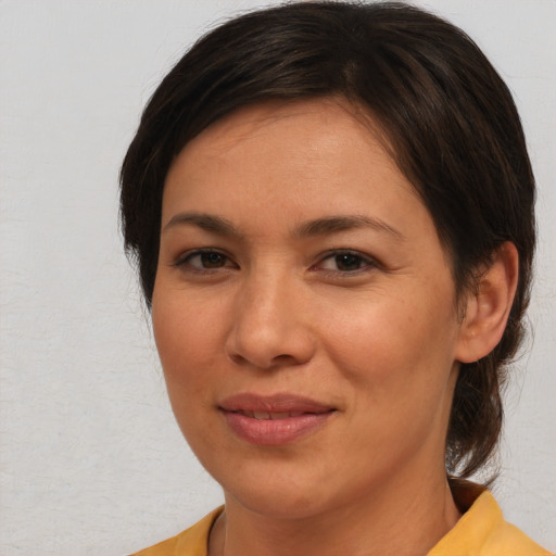 Joyful asian adult female with medium  brown hair and brown eyes
