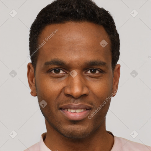 Joyful black young-adult male with short  black hair and brown eyes