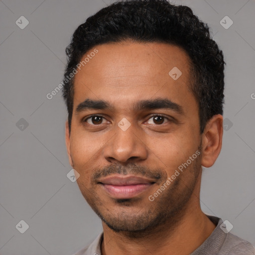 Joyful black young-adult male with short  black hair and brown eyes