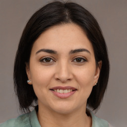 Joyful white young-adult female with medium  brown hair and brown eyes