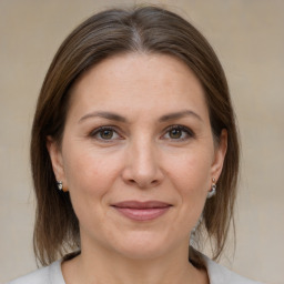 Joyful white adult female with medium  brown hair and brown eyes