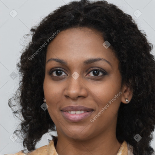 Joyful black young-adult female with long  brown hair and brown eyes