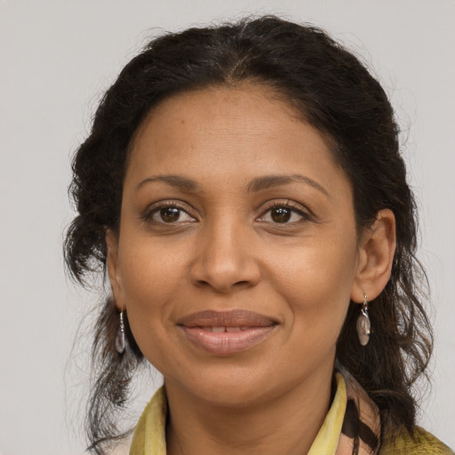 Joyful black adult female with long  brown hair and brown eyes