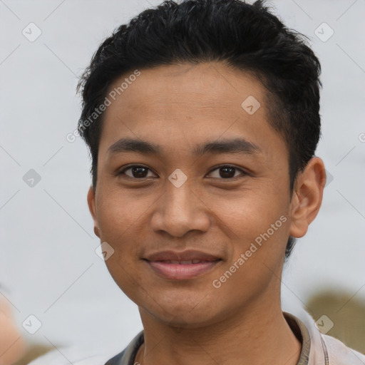 Joyful asian young-adult male with short  black hair and brown eyes