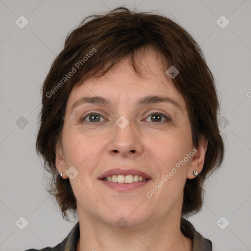 Joyful white adult female with medium  brown hair and grey eyes