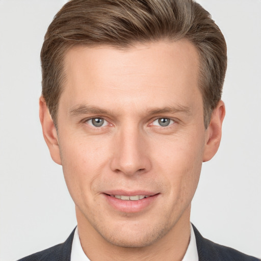 Joyful white adult male with short  brown hair and grey eyes