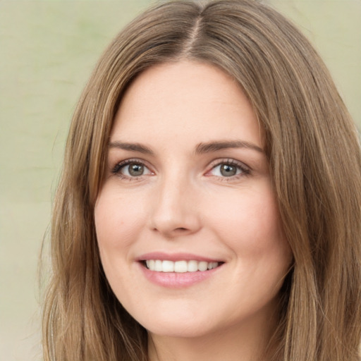 Joyful white young-adult female with long  brown hair and green eyes