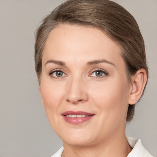 Joyful white adult female with medium  brown hair and brown eyes